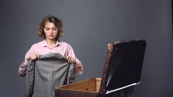 Clothes in Suitcase. Young Woman Packing Traveler Case.