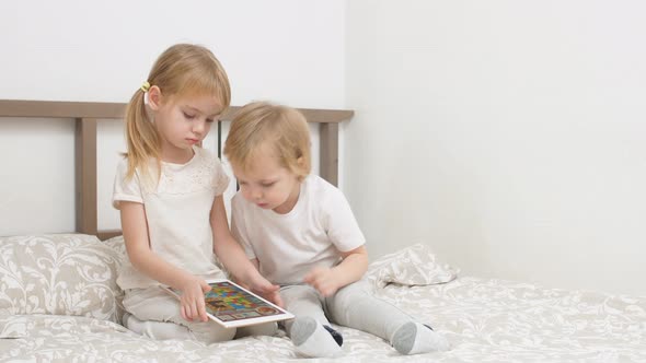 Attractive Children Use Modern Gadget, Holding Tablet in Hands