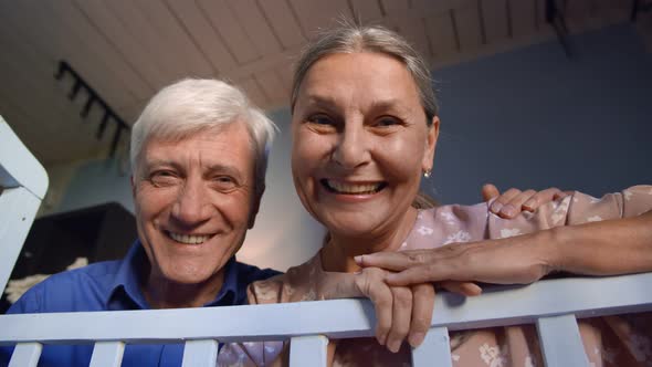 Happy Loving Grandparents Talking To Newborn Grandchild in Blue Crib