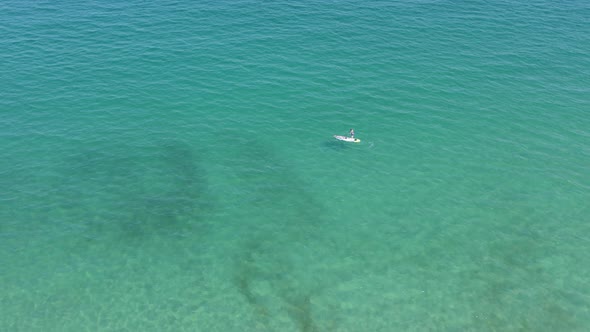 Aerial View of White Sailboat in Calm Turquoise Sea