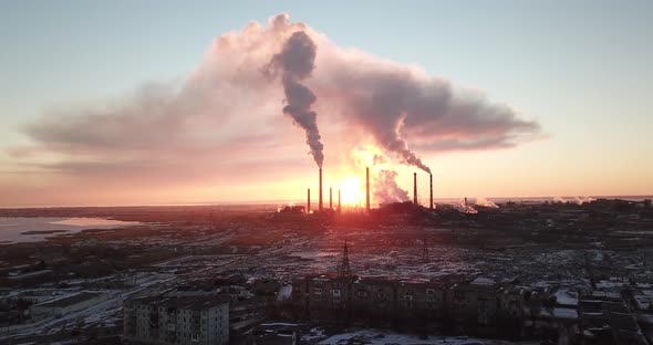 Epic Sunset on The Background of A Smoking Factory. Shooting with The Drone