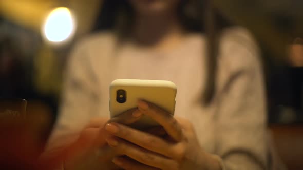 Young Lady Typing on Smartphone Checking Mail, Online Hotel Booking, Application