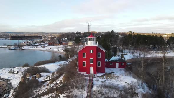 Red lighthouse located in Marquette, Michigan in the winter.