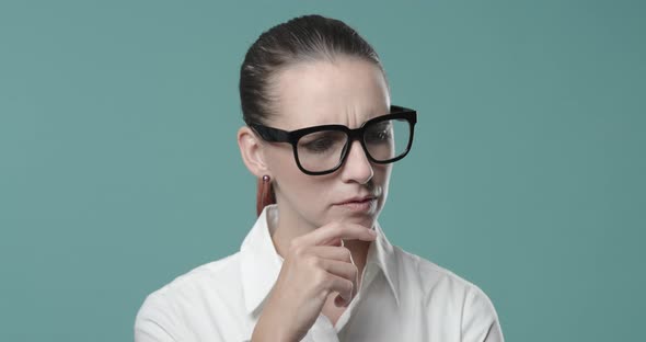 Happy businesswoman pointing upwards and smiling