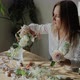 Woman Arranging Flowers at Table - VideoHive Item for Sale