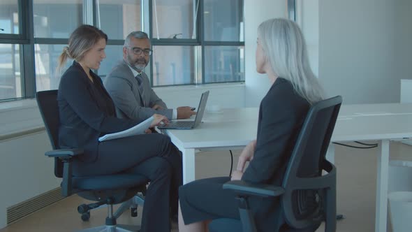 Fair Haired Female Professional Meeting and Talking To Employer