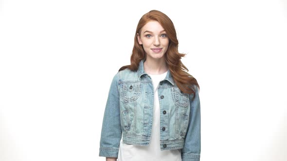 Lifestyle Concept: Happy Redheaded Girl in Denim Showing Peace Gesture To Camera While Standing