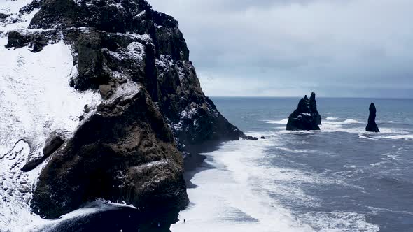 Basalt Rocks Troll Toes on Black Beach at Storm