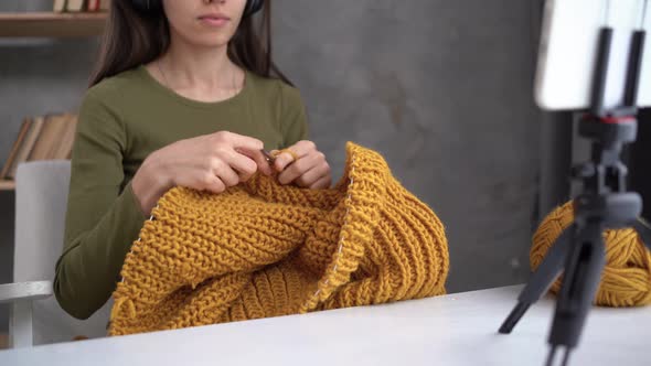 Online Hobby Concept Woman Knits a Sweater with Woolen Threads on Camera Knitting and Needlework