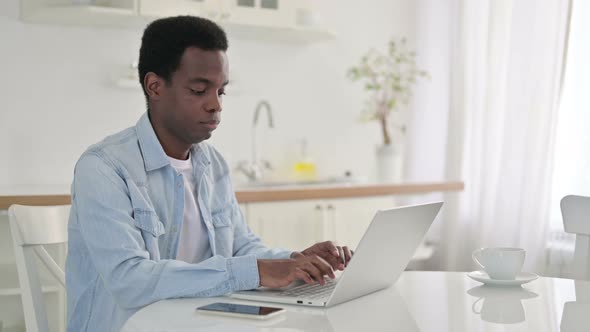 African Man with Laptop Saying No with Finger 