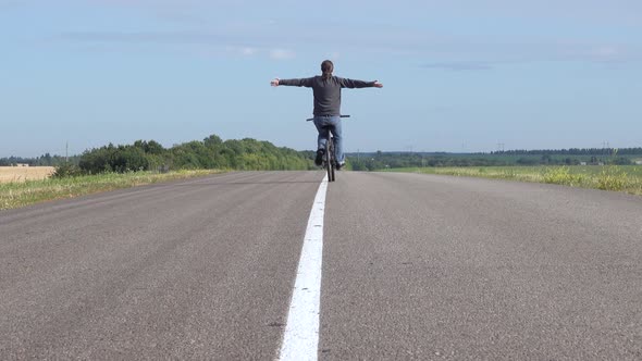 Man on Bicycle with Outstretched Hands