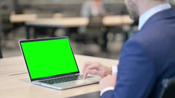 Businessman Working on Laptop with Green Chroma Screen