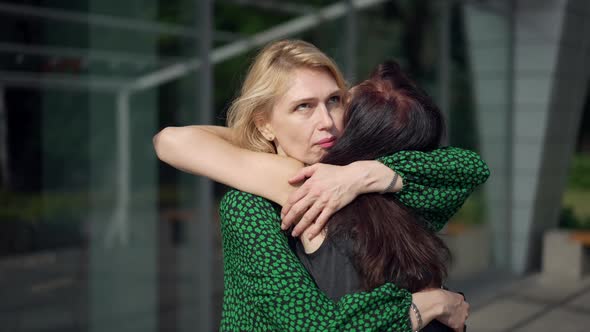 Hypocritical Woman Hugging Friend with Dissatisfied Annoyed Facial Expression