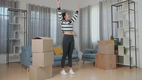 Happy Young Asian Woman Celebrating Finish Carrying Cardboard Box With Stuff Into A New House