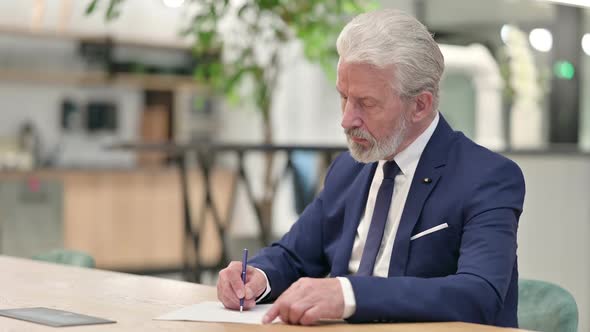 Hardworking Senior Old Businessman Doing Paperwork