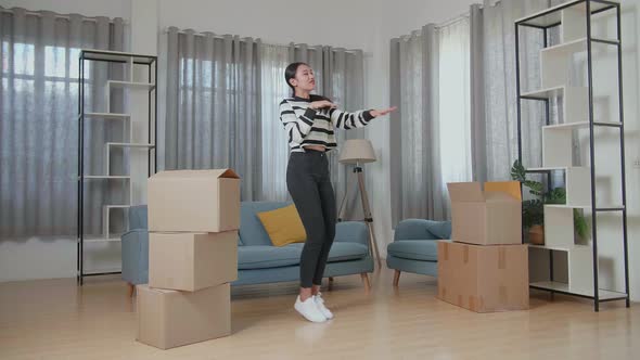 Happy Young Asian Woman Celebrating Finish Carrying Cardboard Box With Stuff Into A New House