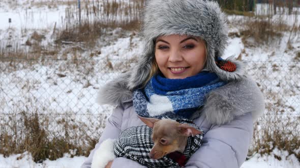 Woman with Little Dog Outside in Winter