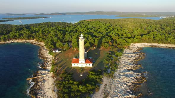 Flying over lighthouse, Croatia with a forest in the background