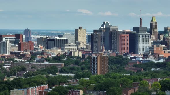 Baltimore city skyline view. Aerial reveals homes and skyscrapers on sunny summer day.