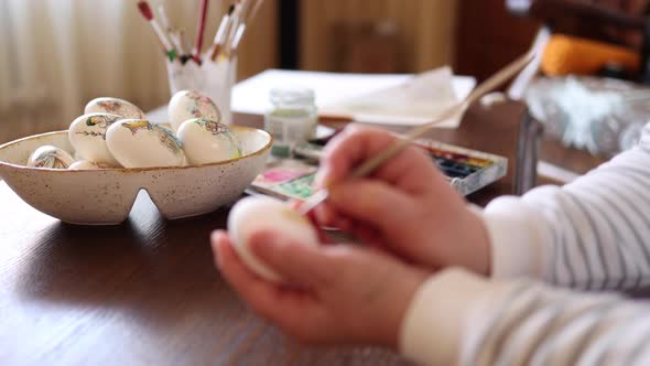 Defocudes of Woman Painting a Water Colors on Fantasy Chicken Eggs for Easter Egg Festival