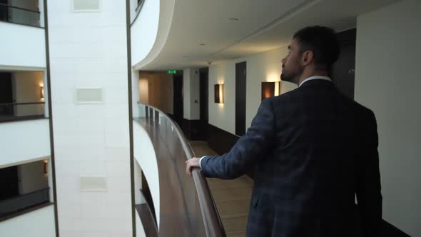 Interested Male Guest Looking at Hotel Interior