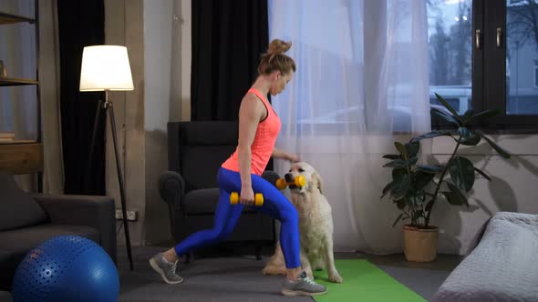 Fit Woman with Dog Doing Lunge Excercise at Home