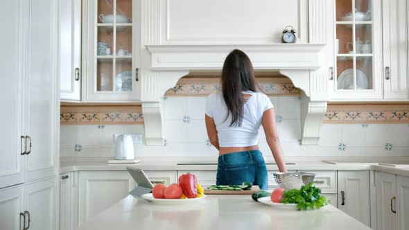 Happy Smiling Woman Dancing and Having Fun Playing with Tomato in Kitchen at Home