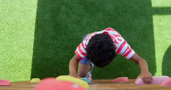 High angle view of African American schoolboy playing in school playground on a sunny day 4k