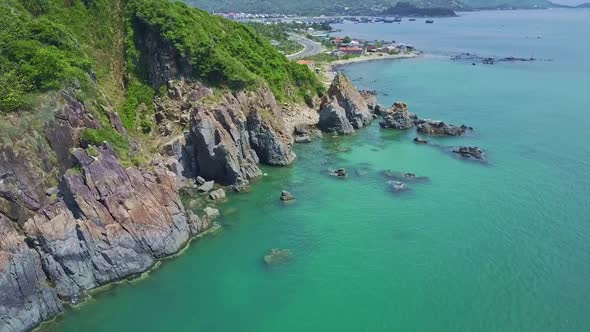 Flycam Approaches From Azure Bay Close To Rocky Coast