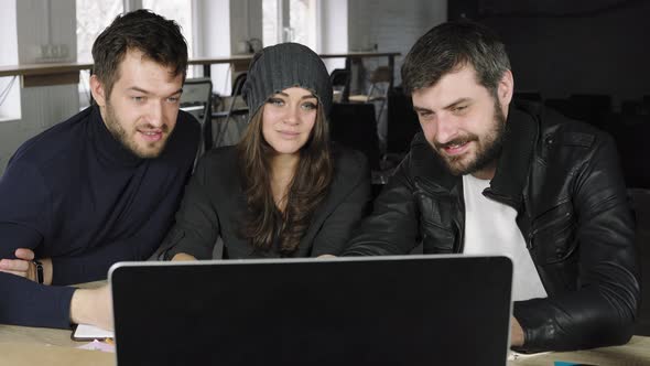 Team of Young Professionals Watching a Video in a Creative Office