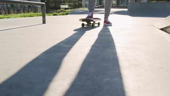 Low section of caucasian man skateboarding at a skatepark