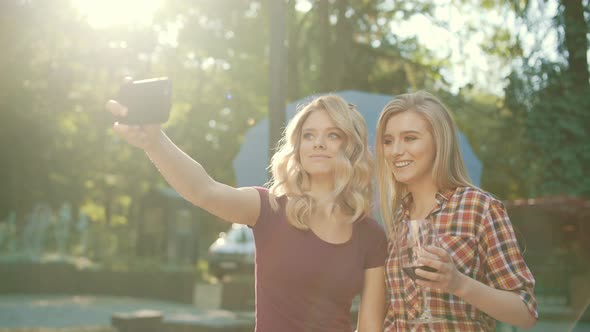 Happy Friends Taking Photos Outdoors. Girls Having Fun