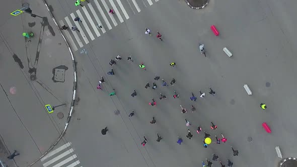 Top Down Aerial Shot of Road Intersection with People Running at City Marathon