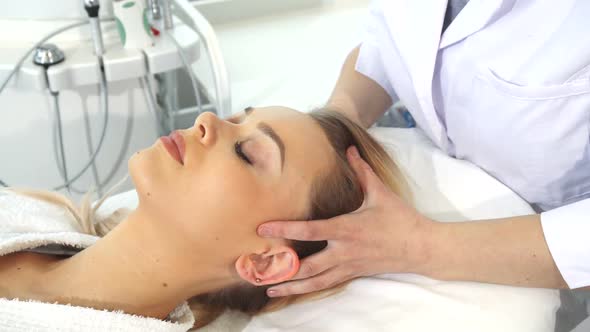 Cosmetologist Massages Client's Head