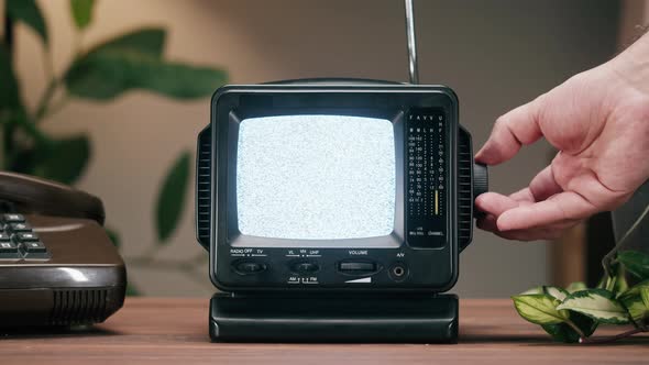 Small Old Television with Grey Interference Screen on Home Background