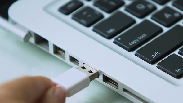 White USB Connected to Laptop, Smartphone Charger, Data Transfer, Cybersecurity