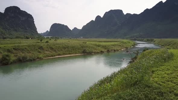 Bird Eye View Winding River Between Green Peanut Fields