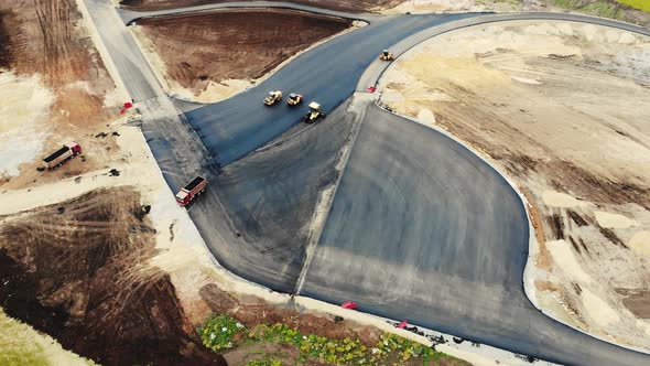 Aerial View of the Yellow Road Rollers That Lay the Asphalt of the Test Ground for Cars