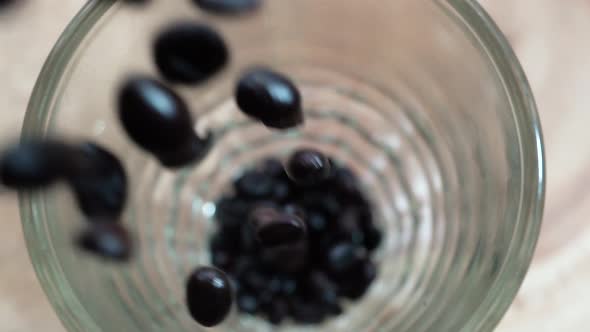 Freshly Roasted Aromatic Coffee Beans Pouring Inside Clear Glass