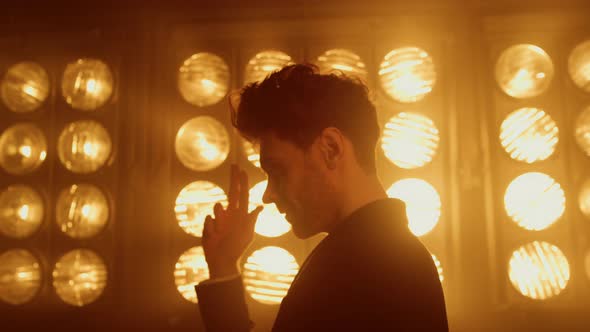 Attractive Man Showing Shooting Gesture By Hand Standing Club Stage Close Up