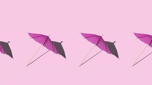 summer mockup with many pink beach or cocktail umbrellas at midday sun with hard shadows