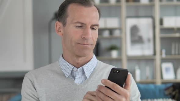 Portrait of Middle Aged Man Busy Using Smartphone