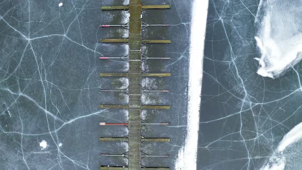 Wooden Jetty Of Vik Bathavn By Frozen Lake Of Steinsfjorden At WInter In Norway. - aerial, top down