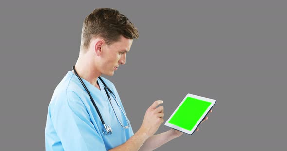 Male surgeon using digital tablet