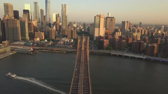 Flight Over Brooklyn Bridge with View Over Manhattan New York City Skyline at Sunset in