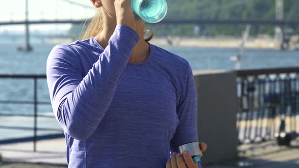 Motion Shoot of Woman Drinking Water on the Beautiful Background