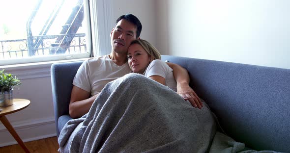 Couple relaxing on sofa