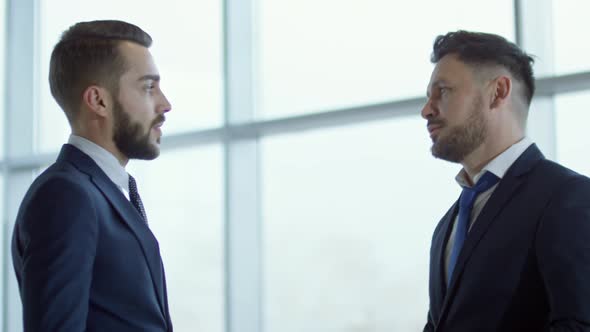 Businessmen in Suits Discussing Work