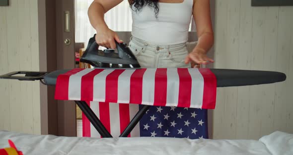 Patriotism Independence Day and Holidays Concept Young Woman Ironing the National American Flag at