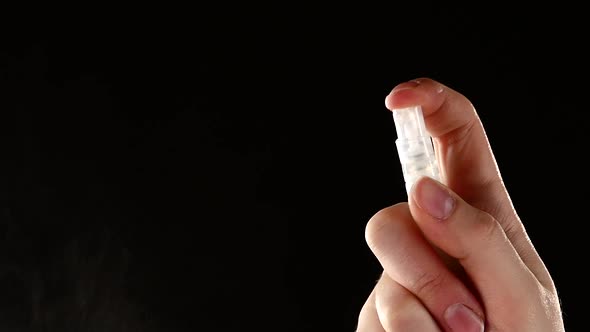 Spray Bottle Drops Like Perfume on Black, Slow Motion, Close Up